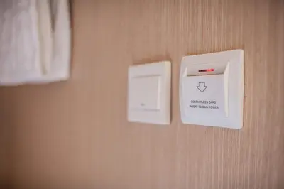 a electrical outlet on a wall next to a bed at Cubic Bed Pratunam in Bangkok