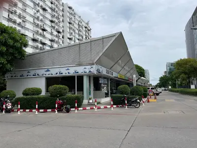 a building with motorcycles parked in a parking lot at Dailyroom by Anna C1-C9 in Nonthaburi
