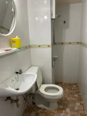 a bathroom with a white toilet and a sink at Dailyroom by Anna C1-C9 in Nonthaburi