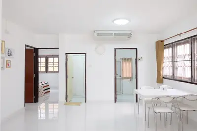 a white room with a white table and chairs at Chatuchak Art & Nature House ( 3-6 pers.) in Bangkok