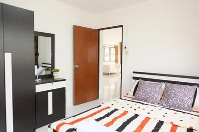 a bedroom with a large bed and a mirror at Chatuchak Art & Nature House ( 3-6 pers.) in Bangkok