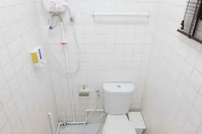 a small bathroom with a toilet and a shower at Chatuchak Art & Nature House ( 3-6 pers.) in Bangkok