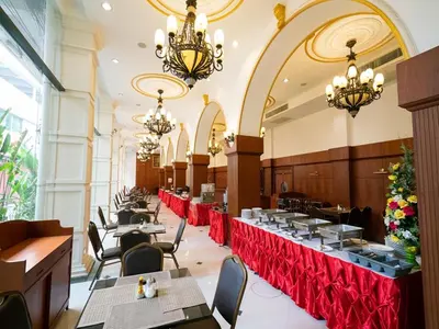 a dining room with tables and chandeliers at The Ecotel Bangkok in Bangkok