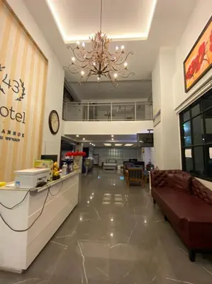 a lobby of a hotel with a couch and a chandelier at 43 Home in Bangkok Noi