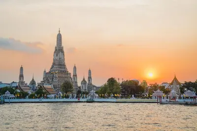 a view of the temple of thailand from the water at sunset at Sala Rattanakosin Bangkok in Bangkok