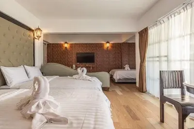 a bedroom with two beds with white towels on them at Infinite Hotel in Bangkok