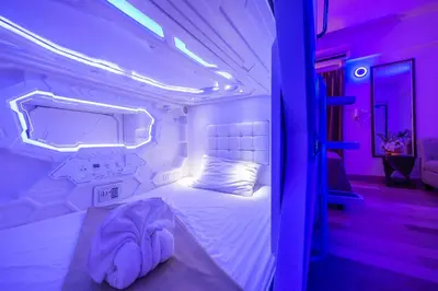 a bedroom with a bed in a room with purple lights at Infinite Hotel in Bangkok
