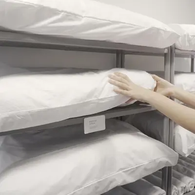 a person putting a pillow on a bunk bed at Chocolate box mint in Bangkok