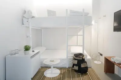 a white room with a bed and a desk at Chocolate box mint in Bangkok