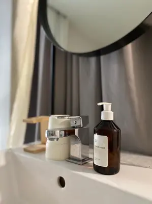 a bottle of soap sitting on top of a bathroom sink at Chocolate box mint in Bangkok