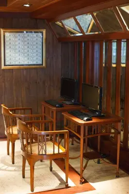 a room with a desk with a computer and two chairs at Chang Siam Inn in Bangkok