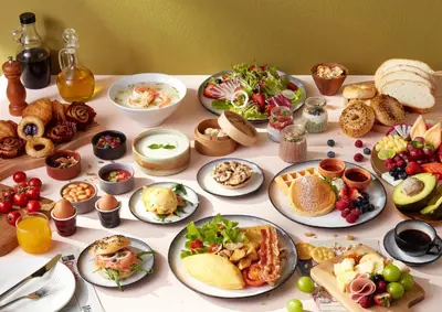 a table with many plates of food on it at Avani Sukhumvit Bangkok Hotel in Bangkok