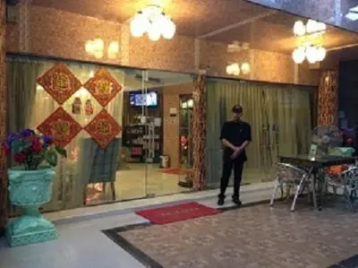 a man standing in a room in a building at Penang Palace in Bangkok