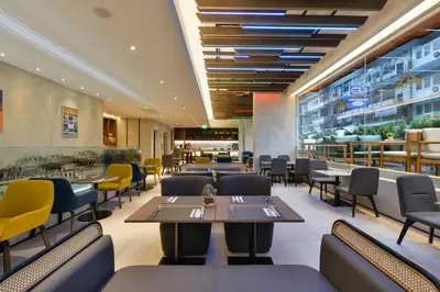 a dining room with tables and chairs in a restaurant at Aspira One Sutthisan in Bangkok