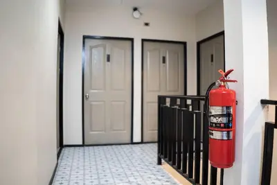 a fire extinguisher hanging on the side of a building at Kaelyn Cozy Living in Bangkok