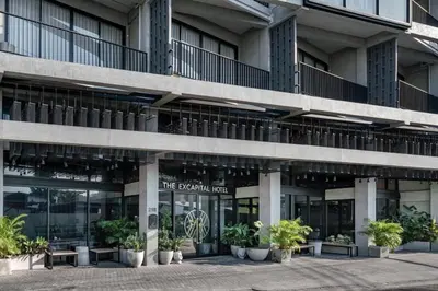 an office building with plants in front of it at Palette The Ex Capital Hotel Bangkok in Bangkok