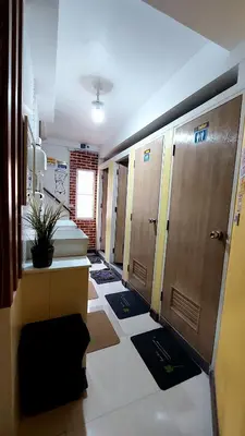 a locker room with lockers and mats on the floor at Great House 99 in Bangkok