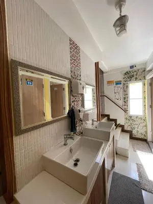 a large bathroom with two sinks and a mirror at Great House 99 in Bangkok