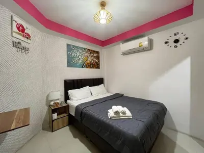 a bedroom with a bed with a black bedspread at Great House 99 in Bangkok