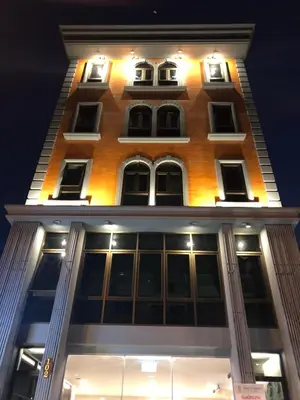 a tall building with windows at night at Rich8 Hostel in Bangkok