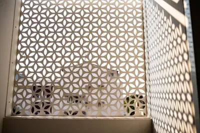 a glass door with a white pattern on a wall at Rich8 Hostel in Bangkok