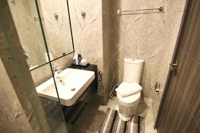 a bathroom with a toilet and a sink and a shower at Luxurious & Romantic in the Heart of BKK#H MRT/BTS! in Bangkok