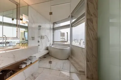 a bathroom with a tub and a sink at Bangkok Marriott Hotel Sukhumvit in Bangkok
