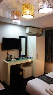 a hotel room with a desk and a bed at V30 Sukhumvit in Bangkok