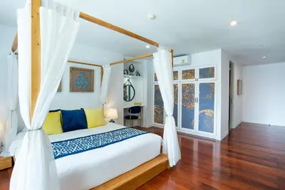 a bedroom with a bed with a canopy at Benviar Tonson Residence in Bangkok