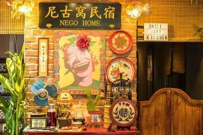 a wall with a picture of a head on it at Nego Home Ancient Inn in Bangkok
