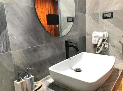 a bathroom with a white sink and a mirror at Nego Home Ancient Inn in Bangkok