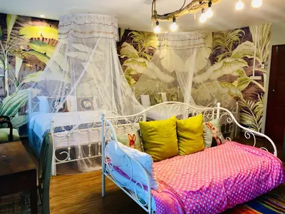 a bedroom with a white bed with colorful pillows at Nego Home Ancient Inn in Bangkok