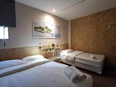 a hotel room with two beds in a room at FORESTTEL.BKK in Bangkok