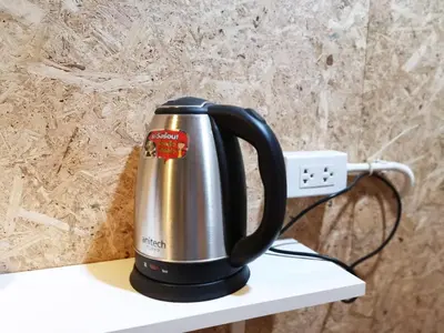 a black and silver kettle sitting on a shelf at FORESTTEL.BKK in Bangkok