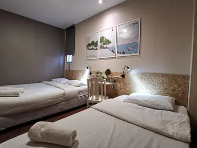 two beds in a hotel room with two beds sidx sidx sidx at FORESTTEL.BKK in Bangkok