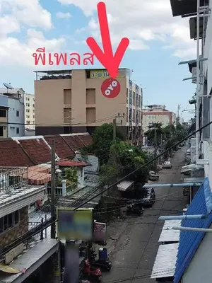 a view of a city with a sign on a building at พีเพลส in Bangkok