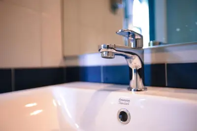 a bathroom sink with a faucet and a mirror at Bed garden 26 in Bangkok