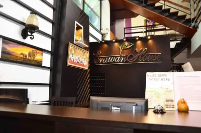 a bar in a restaurant with a sign on the wall at Erawan House in Bangkok