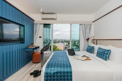a hotel room with a bed with a laptop on it at Hotel Amber Sukhumvit 85 in Bangkok
