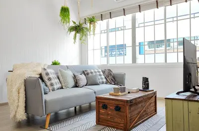 a living room with a couch and a coffee table at Hide and Seek Boutique Hometel in Bangkok