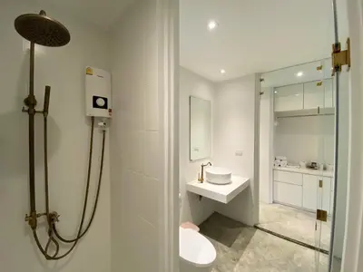 a bathroom with a toilet and a sink and a shower at Vali Villa Bangkok in Bangkok