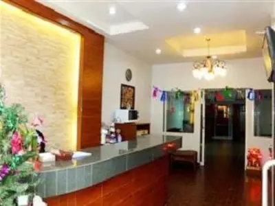 a living room with a counter and a room with at Orchid Inn in Bangkok