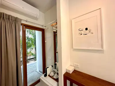 a bathroom with a window and a picture on the wall at SUNKISS in Bangkok Noi
