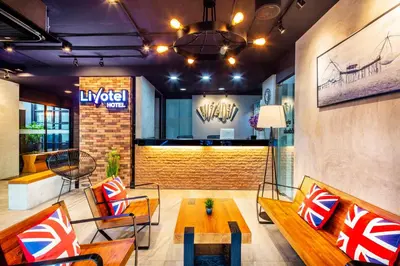 a lobby of a luxury hotel with a table and chairs at Livotel Express Hotel Bang Kruai Nonthaburi - No Parking in Nonthaburi