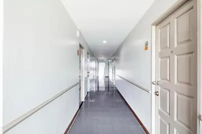 a hallway with white walls and a white door at Livotel Express Hotel Bang Kruai Nonthaburi - No Parking in Nonthaburi
