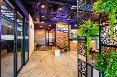 a lobby of a building with plants on the walls at Livotel Express Hotel Bang Kruai Nonthaburi - No Parking in Nonthaburi