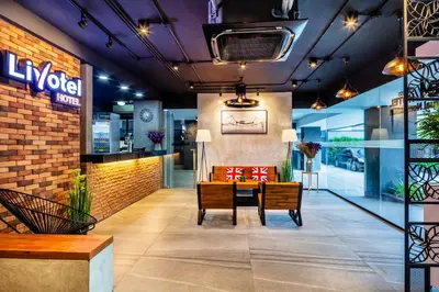 a lobby of a hotel with a table and chairs at Livotel Express Hotel Bang Kruai Nonthaburi - No Parking in Nonthaburi