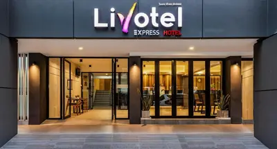 a store front of a luxury apartment building with revolving doors at Livotel Express Hotel Ramkhamhaeng 50 Bangkok - No Parking in Bangkok