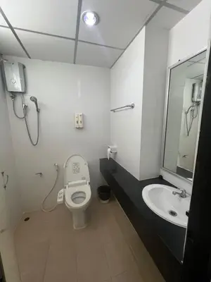 a bathroom with a toilet and a sink at Komol Residence Bangkok in Bangkok