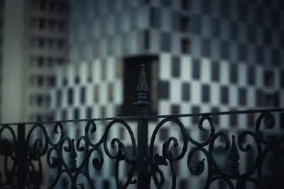 a black fence with a building in the background at Daraya Boutique Hotel in Bangkok